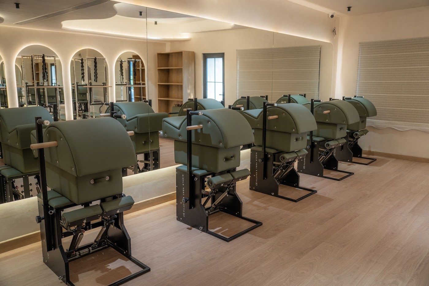 Pilates chairs facing arched mirrors
